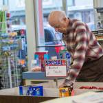 Rudy Hiener, who works at Bay Variety in Port Angeles, organizes merchandise Tuesday. (Jesse Major/Peninsula Daily News)