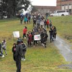 Port Townsend High School students walk out of classes Wednesday to rally at the baseball field. The half-hour demonstration included a silent tribute and a rally cry for something to be done. The students formed a human peace sign before returning to class. (Jeannie McMacken/Peninsula Daily News)