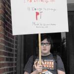 Student Bryan Fenton displays the sign he made to carry during the walkout at Port Townsend High School. (Jeannie McMacken/Peninsula Daily News)
