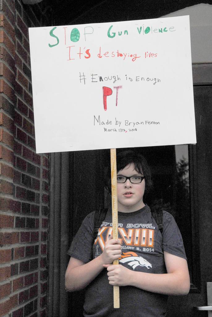 Student Bryan Fenton displays the sign he made to carry during the walkout at Port Townsend High School. (Jeannie McMacken/Peninsula Daily News)