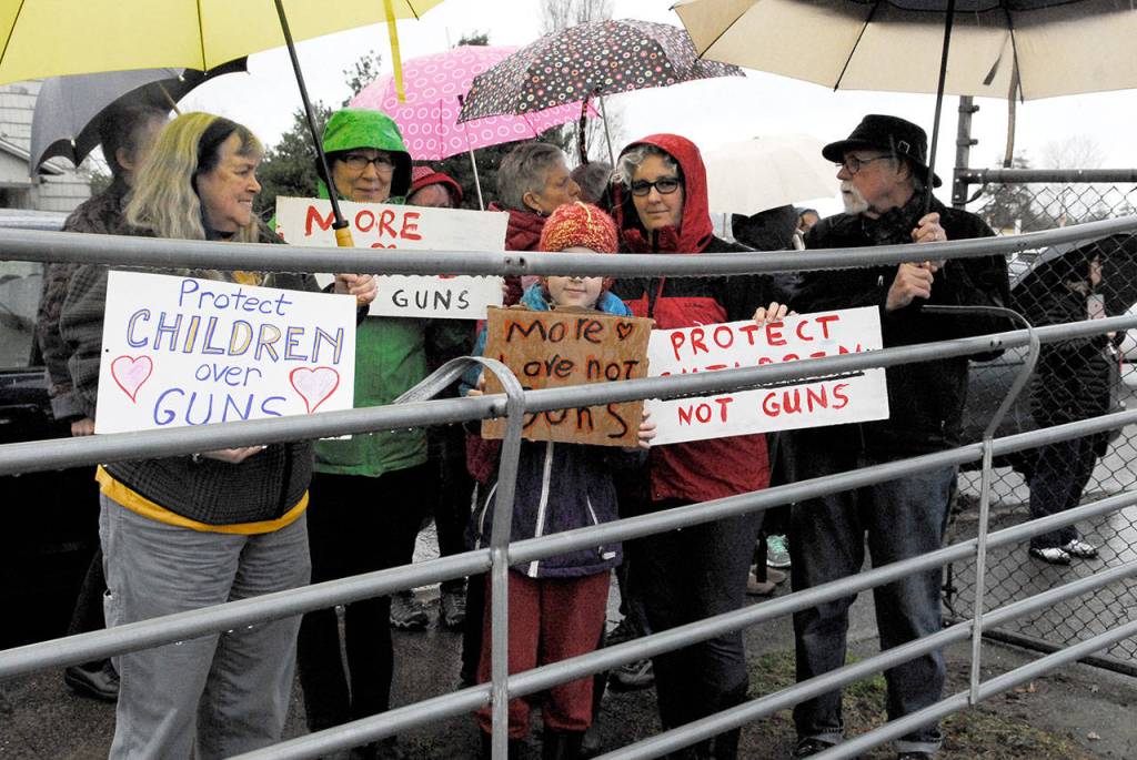 Community supporters rallied at Port Townsend High School to support the student walkout Wednesday. About 75 people held signs and cheered on the students as they demonstrated to bring awareness to gun violence in schools. (Jeannie McMacken/Peninsula Daily News)
