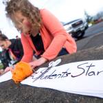 Students make signs before the walkout at Port Angeles High School on Wednesday. (Jesse Major/Peninsula Daily News)