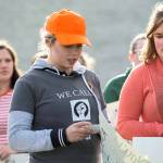Port Angeles High School Senior Emily Menshew, 17, reads the name of one of the 17 people killed in a Florida high school last month. (Jesse Major/Peninsula Daily News)