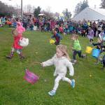Youngsters race from the starting area to collect prize-filled eggs during the 2017 KONP Easter Egg Hunt at the Clallam County Fairgrounds in Port Angeles. (Keith Thorpe/Peninsula Daily News)