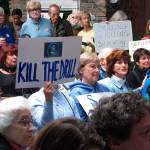 In this Feb. 14, photo, people hold signs protesting President Donald Trumps plan to allow offshore oil and gas drilling along most of the nations coastline at a hearing in Hamilton, N.J. (Wayne Parry/The Associated Press)