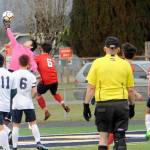 Lonnie Archibald/for Peninsula Daily News Forks goalkeeper Gabriel Terrones (in pink) leaps to make a save in the Spartans 3-0 shutout victory over Port Townsend on Wednesday at Spartan Stadium in Forks.