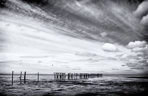 Clouds and Pilings by Ken Dvorak is on exhibit at Blue Whole Gallery.