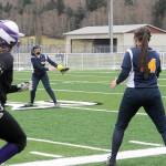 Lonnie Archibald/for Peninsula Daily News                                Quilcenes Erin Macedo, left, was safe at first as Forks second baseman Myah Rondeau throws to first baseman Natalie Lausche during the first softball game played on the artificial turf at Spartan Stadium in Forks.
