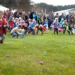 Youngsters race to collect eggs containing prizes during Saturdays 40th annuyal KONP Easter Egg Hunt at the Clallam County Fairgrounds in Port Angeles. Besides thousands of eggs, registered children were eligable for drawings for additional prizes. (Keith Thorpe/Peninsula Daily News)