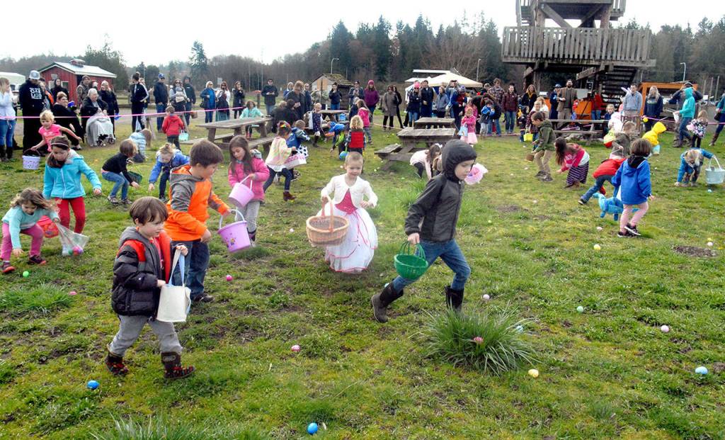 Children search out prize-filled eggs during Saturdays Great 2018 Easter EGGstravaganza at the Sequim Pumpkin Patch. The event, hosted by community radio station KSQM, also featured prizes, pony rides, a bounce house and photo with the Easter bunny. (Keith Thorpe/Peninsula Daily News)