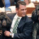 In this Oct. 7, 2015, file photo, Judge John Trucilla meets with therapy dogs Jett, left, and True in his courtroom at the Erie County Courthouse in Erie, Pa., where therapy dogs visit courtrooms during childrens legal hearings. (Jack Hanrahan/Erie Times-News via AP)