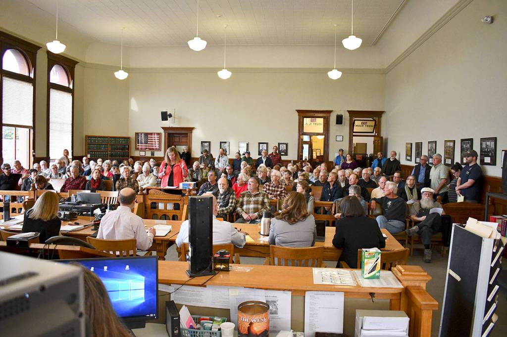 The Jefferson County Board of Commissioners hears testimony from the public Monday night on a proposed development agreement for the Pleasant Harbor Master Planned Resort near Brinnon. Close to 70 community members voiced their opinions during the 3½ hour hearing, including Charlotte Clark of Brinnon, seen giving comment here. (Jeannie McMacken/Peninsula Daily News)