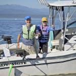 John Reed and Karen Overstreet, both of Seattle, show off a chinook caught while fishing at Midchannel Bank off Port Townsend in 2016.                                Steve Mullensky/for Peninsula Daily News