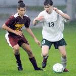 Keith Thorpe/Peninsula Daily News Kingstons Judah Andrews, left, and Port Angeles Stuart Methner battle for the ball in a rain-soaked first half on Friday evening at Port Angeles Civic Field.