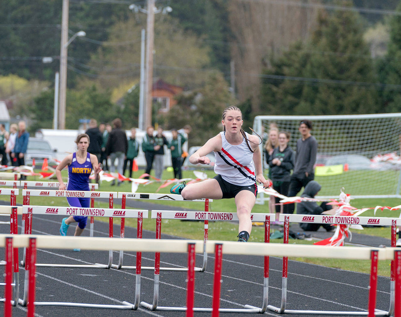 Port Townsends Aubry Botkin distances herself from her nearest competitor and easily wins the girls 100 meter hurdles during a track meet at Blue Heron Middle School on Friday. (Steve Mullensky/for Peninsula Daily News)
