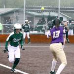 Dave Logan/for Peninsula Daily News Port Angeles Sierra Robinson attempts to beat out a bunt single while Sequim first baseman Latisha Robideau awaits the throw from pitcher Isabelle Dennis. Robinson was called out in a game played in the rain at Billy Whiteshoes Memorial Park.
