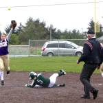 Sequims Bobbi Sparks, left, is unable to catch a high throw to second base on a steal attempt by Port Angeles Natalie Steinman (5). Steinman slid past the base on the slippery artificial turf infield and Sequims Shelby Jones (14) caught the overthrown ball and tagged out Steinman.                                Dave Logan/for Peninsula Daily News