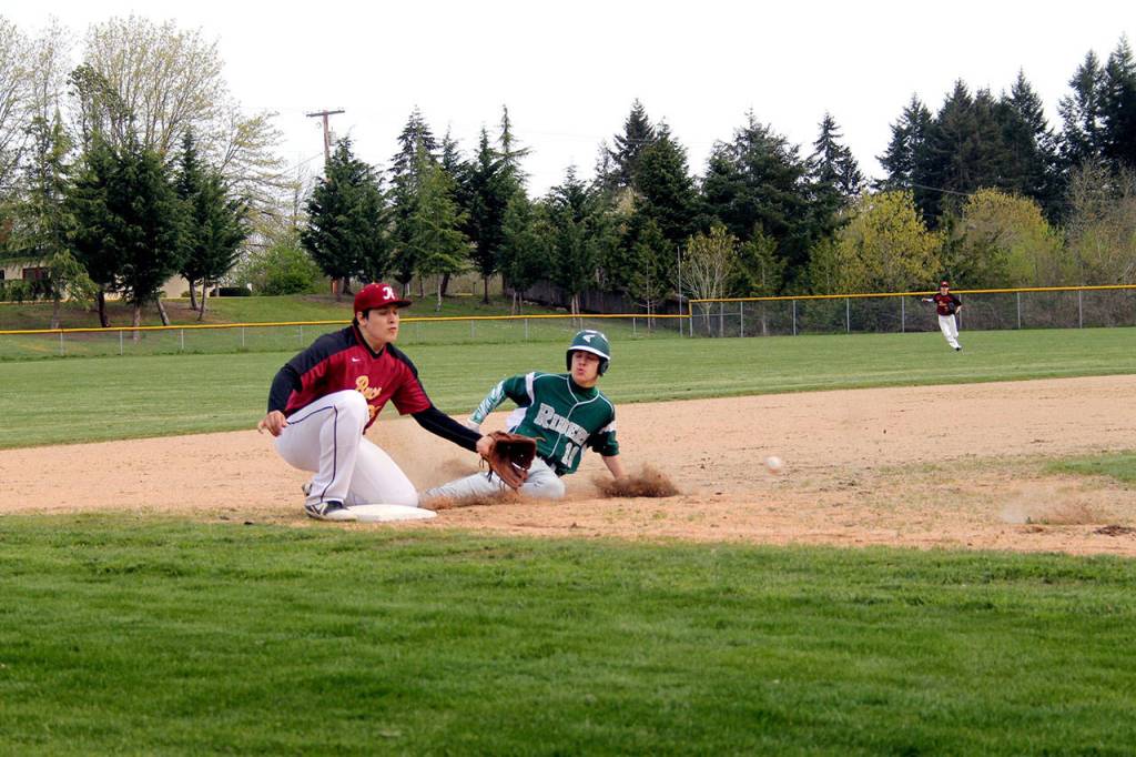 Port Angeles Tyler Bowen slides safely into third base during the Riders 10-1 road win over Kingston on Thursday. (Jacob Moore/Kitsap News Group)