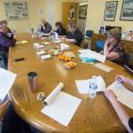Serenity House of Clallam County board members look over a statement telling of Serenity Houses decision to close its shelters May 15 due to lack of funding. (Jesse Major/Peninsula Daily News)