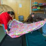 Amanda and Lewis Jones make their bed in Serenity House of Clallam Countys night-by-night shelter Tuesday night. The couple, which moved to Clallam County about nine months ago, has struggled to find housing since a tornado destroyed their Missouri home in 2011. (Jesse Major/Peninsula Daily News)