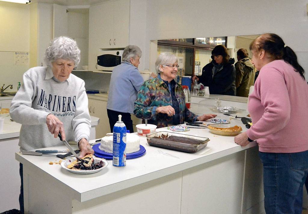 Jennie Hajek, left, and Vicki Kocha of the Agnew Helpful Neighbors Club help serve pie Saturday to celebrate the completion of the McDonald Creek Bridge project. (Matthew Nash/Olympic Peninsula News Group)