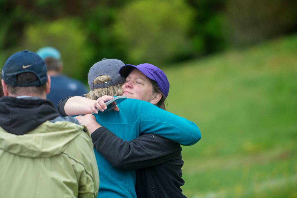 Carrie Sanford hugs one of the runs participants. (Jesse Major/Peninsula Daily News)