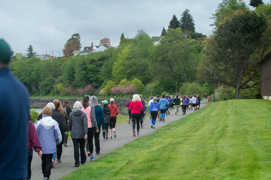 A group of mostly women walk the Olympic Discovery Trail during the Run Without Fear on Sunday. (Jesse Major/Peninsula Daily News)