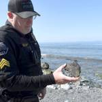 Port Townsend Police Sgt. Garin Williams holds a piece of an object that was found on North Beach Tuesday afternoon. (Jeannie McMacken/Peninsula Daily News)