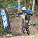 Jesse Major/Peninsula Daily News Matthew Macartney of Fall City makes his way toward the finish line at the NW Cup downhill mountain bike races at Dry Hill Bike Park near Port Angeles last month.