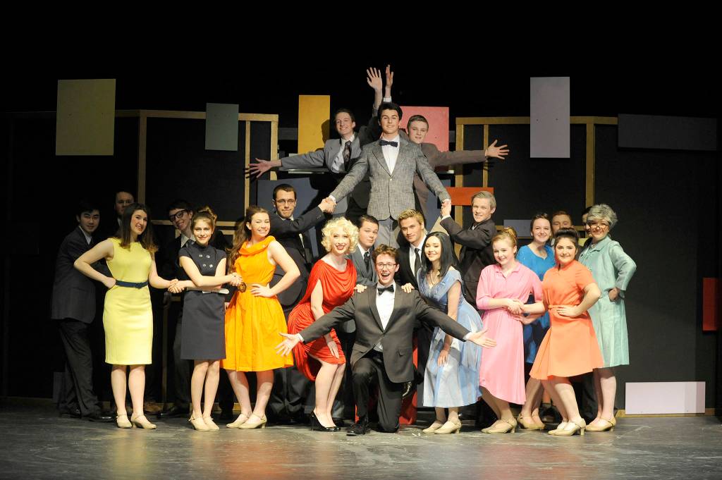 The cast of Sequim High Schools How to Succeed in Business Without Really Trying preps the show for three weekends worth of staged satire. (Erin Hawkins/Olympic Peninsula News Group)