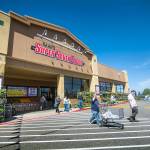 Customers return to their vehicles after shopping at Saars Super Saver Foods in Port Angeles during its opening day on Wednesday. A grand opening celebration is planned for Saturday. (Jesse Major/Peninsula Daily News)