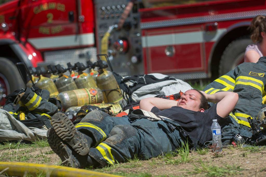 A firefighter rests during the training. (Jesse Major/Peninsula Daily News)