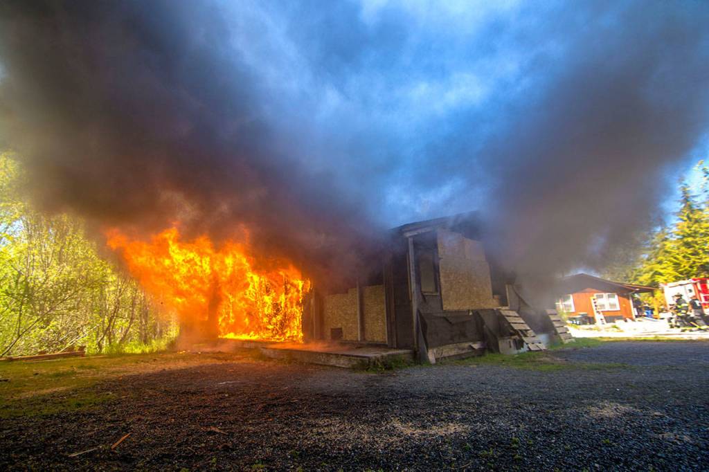 The house used for fire training burns. (Jesse Major/Peninsula Daily News)