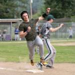 Steve Mullensky/for Peninsula Daily News Quilcenes Olin Reynolds bounces over first base after hitting a single in a loser-out game against the Mount Rainier Lutheran Hawks on Tuesday in Quilcene.