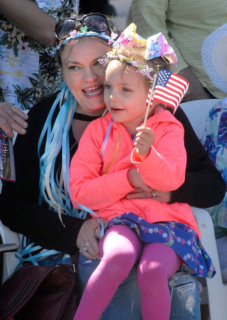 Christa Agostine of Everett and her daughter, Wynter VanEngelen, 4, watch the Irrigation Festival parade as entries make their way west on Washington Street. (Keith Thorpe/Peninsula Daily News)