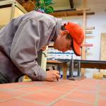 Peninsula College student Levi Bergren paints a set piece for upcoming student-led productions at the school.