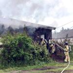 East Jefferson Fire-Rescue firefighters attack a blaze that burned a home in Port Ludlow. (East Jefferson Fire-Rescue)