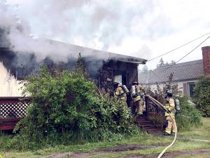 East Jefferson Fire Rescue firefighters attack a blaze that burned a home in Port Ludlow.