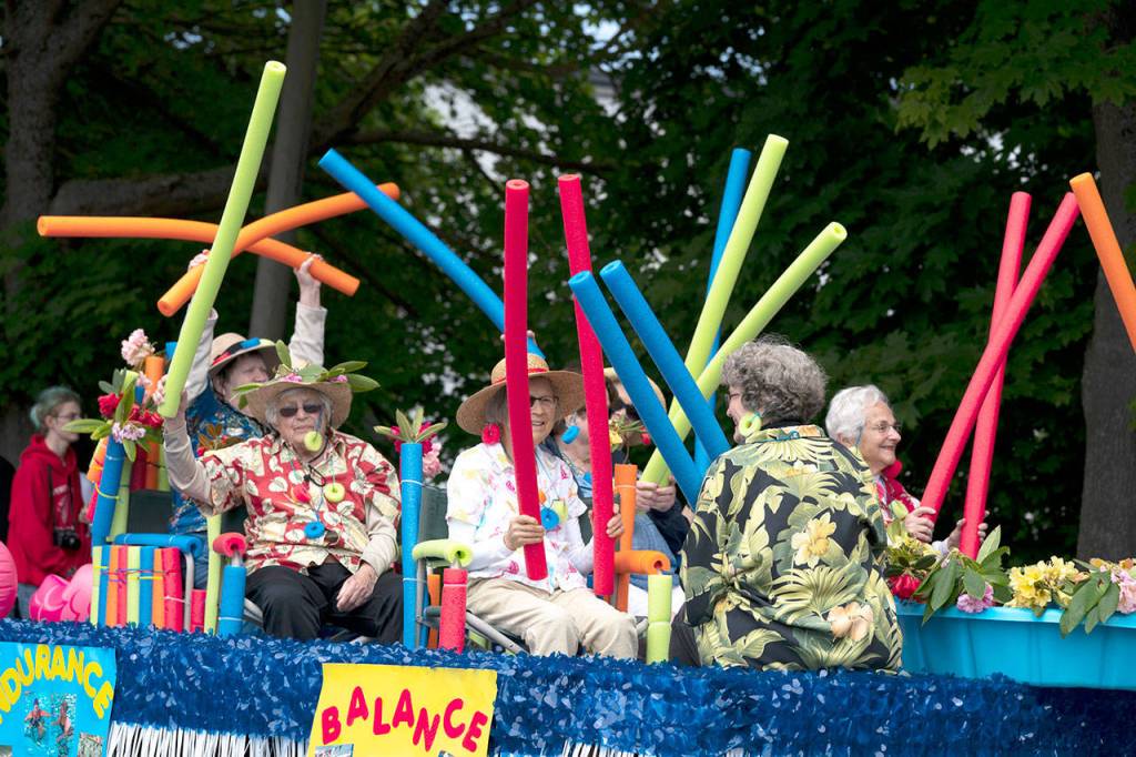 Senior participants in the 2018 Rhody Parade wave spaghetti floats along Monroe Street in Port Townsend on Saturday. (Steve Mullensky/for Peninsula Daily News)