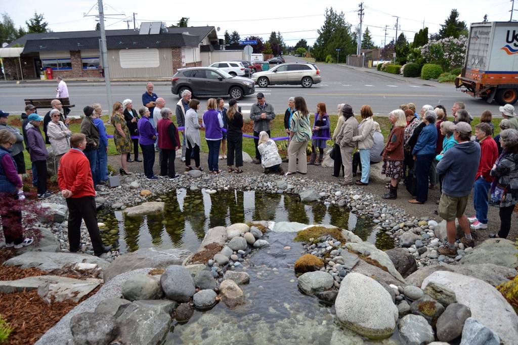 Ty Brown, Sequim operations manager, speaks to the crowd about how the city worked with the Lotzgesell family, Priscilla Hudson and other Sequim Prairie Garden Club members in refurbishing the fountain Pioneer Memorial Park. (Matthew Nash/Olympic Peninsula News Group)