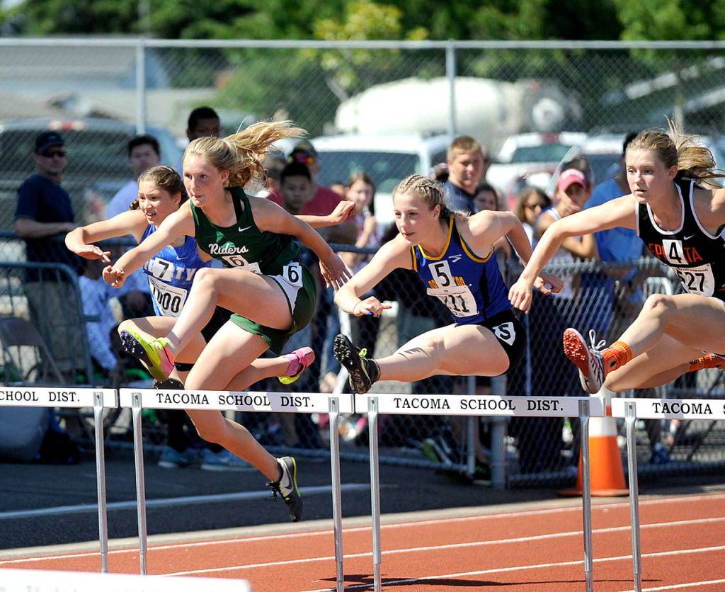 Port Angeles Millie Long, second from left, runs in the preliminaries of the 100-meter hurdles at the 2A state Track and Field Championships at Mount Tahoma High School. Long wasnt able to move on to the finals in the 100 meters, but she won her heat in the 300-meter hurdles. She went on to finish third in the 300 hurdles. (Michael Dashiell/Olympic Peninsula News Group)