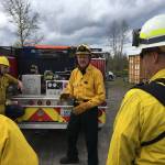 Clallam County Fire District No. 2 Lt. Al Oman, facing the crews, explains the safe operation of pumps on a new brush engine as firefighters look on. (Clallam County Fire District No. 2)
