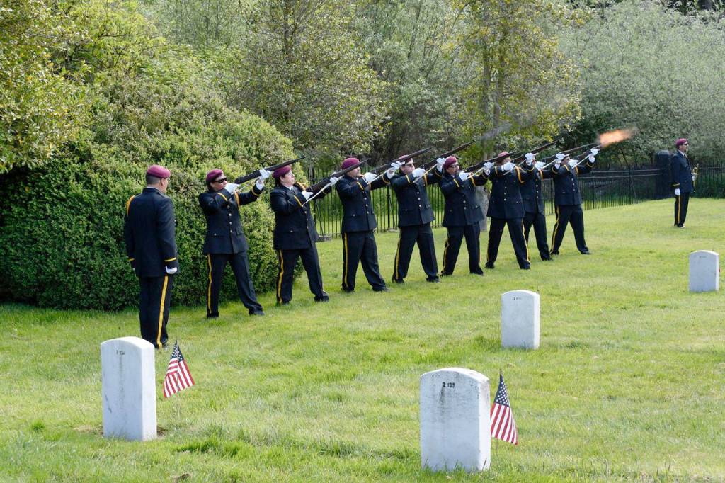 At the Fort Worden Cemetery, members of a rifle honor guard fire their weapons three times in the traditional ceremony to honor the fallen. (Jeannie McMacken/Peninsula Daily News)