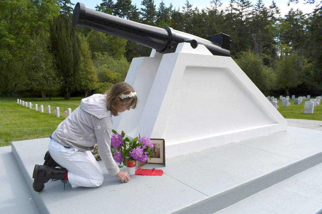 At the Fort Worden Cemetery, Jana Allen of Port Townsend remembers her grandfather, William Dahlstrom, who trained troops at Fort Worden. An immigrant from Sweden, Dahlstrom served in the Army. (Jeannie McMacken/Peninsula Daily News)