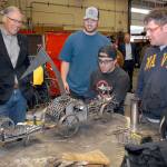 Washington Gov. Jay Inslee, left, examines a steampunk-themed metal artwork created by Peninsula College welding students, from left, Ellis Henderson of Port Townsend, and Nathan Hofer and Matthew Weaver of Port Angeles during the governors tour of the colleges welding class on the Port Angeles campus on Thursday. The shop tour was part of a presentation on economic opportunities and partnerships in the maritime industries on the North Olympic Peninsula. (Keith Thorpe/Peninsula Daily News)