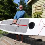 Chef Arran Stark is ready for Mondays inaugural Seventy48 human-powered race from Tacoma to Port Townsend. He says his state-of-the-art paddle board will carry him 70 miles in 20 hours, with no stops. HIs gourmet fuel will include bone broth and a natural roast beef sandwich. (Jeannie McMacken/Peninsula Daily News)