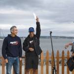 Greg Barton, left, and Ken Olney received a $11,700 check Wednesday for their first-place finish in the inaugural Seventy48 human-powered boat race. Race Boss Daniel Evans, right, said the team was strong from the start and set a blistering pace. Of the 117 teams who entered the event, six left the race with soreness, weariness and a broken oar. (Jeannie McMacken/Peninsula Daily News)
