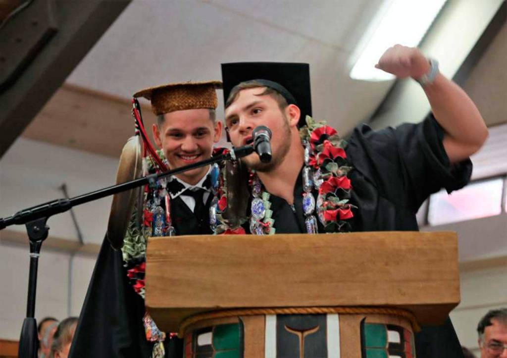 Benjamin Greene and Daniel Kilmer present a speech on the Makah flag during the Neah Bay High School graduation Saturday at the school gym. (Marla Tolliver)