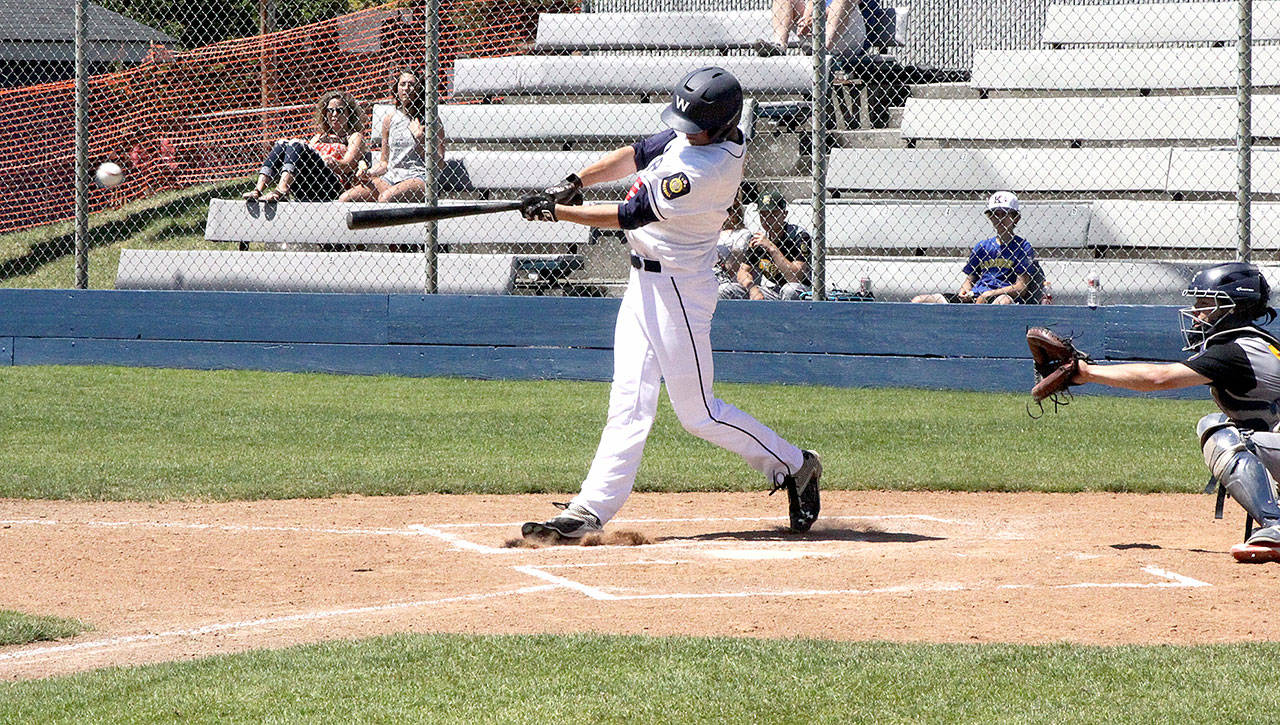 Ethan Flodstrom of the Wilder Seniors hits a single into right field that scores a pair of runners for Wilder to take the early lead in their game against the ESC Tigers of Auburn. (Dave Logan/for Peninsula Daily News)