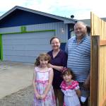 <strong>Matthew Nash</strong>/Olympic Peninsula News Group                                Margie and Mark Powless stand with their granddaughters Bailey and Samantha Johnson along their new fence and painted home that volunteers with Habitat for Humanity and the city of Sequim worked on for Sequim Service Fest. Its beautiful, Margie said. They did such a great job and theyre such nice people, too.